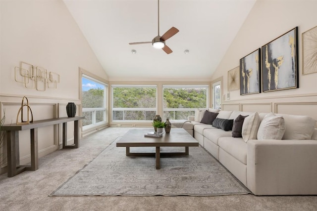 living room with light carpet, a wealth of natural light, and high vaulted ceiling