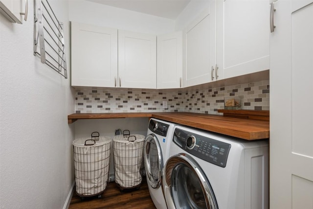 clothes washing area featuring cabinets, dark wood-type flooring, and independent washer and dryer