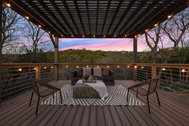 deck at dusk featuring an outdoor living space and a pergola