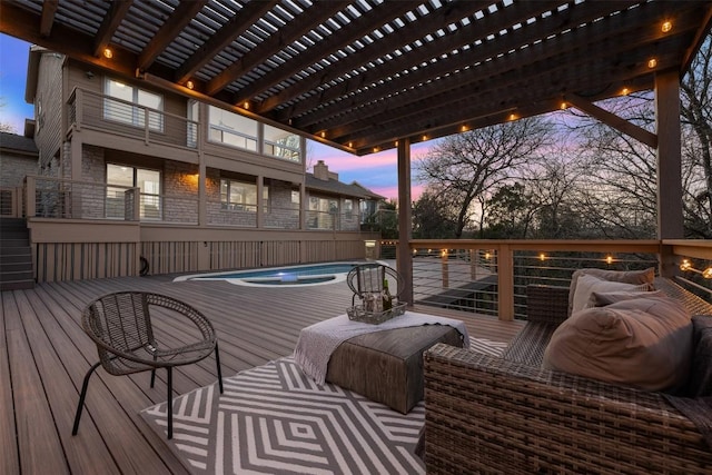 deck at dusk featuring a pool and a pergola