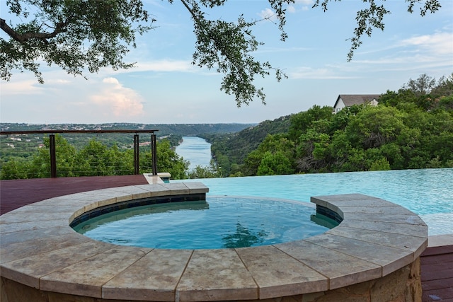 view of swimming pool featuring a water view