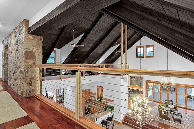 corridor with hardwood / wood-style flooring, a notable chandelier, wood ceiling, and lofted ceiling with beams