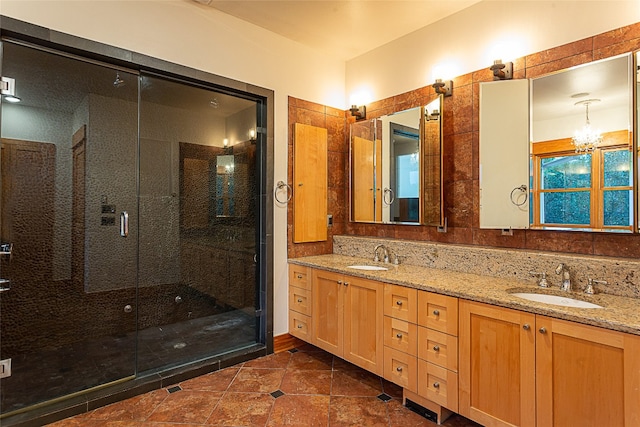 bathroom featuring vanity and a shower with door