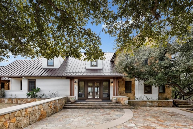 modern farmhouse style home featuring french doors