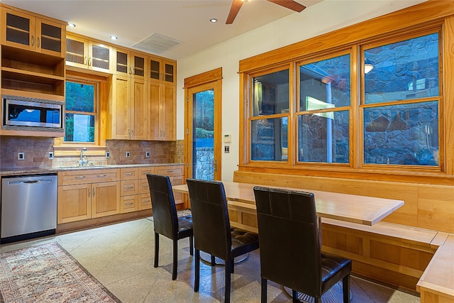 kitchen with sink, ceiling fan, appliances with stainless steel finishes, tasteful backsplash, and light brown cabinetry