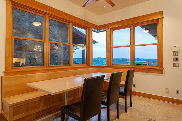 dining area with a mountain view, ceiling fan, and breakfast area