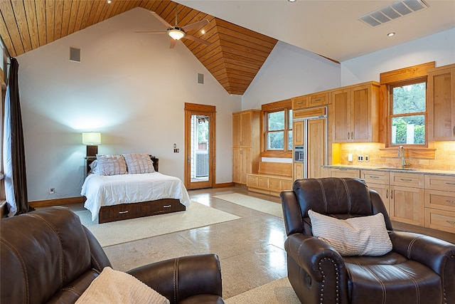 bedroom with paneled built in refrigerator, sink, high vaulted ceiling, and access to exterior