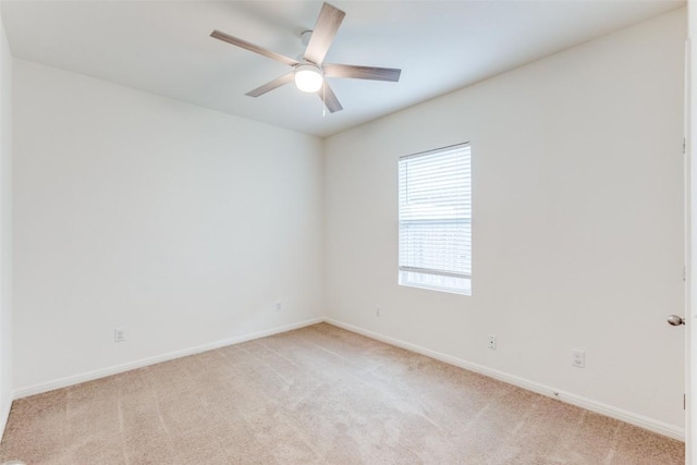 unfurnished room with light colored carpet and ceiling fan