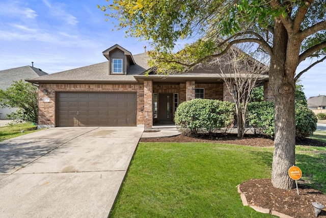 view of front of property with a garage and a front lawn