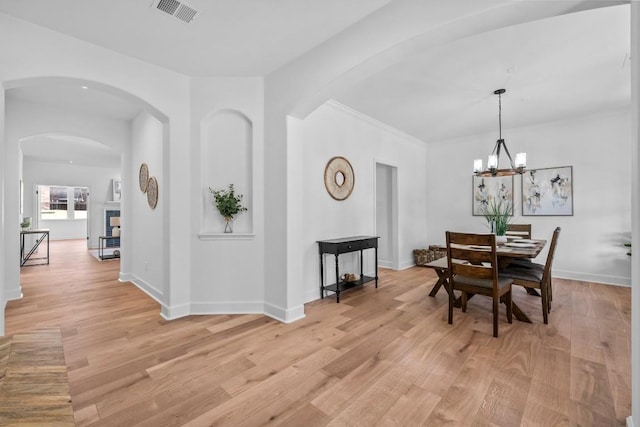 dining room featuring an inviting chandelier and light hardwood / wood-style flooring