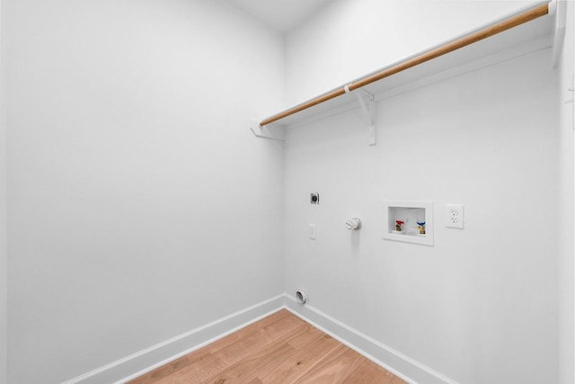 clothes washing area with hookup for a washing machine, hardwood / wood-style floors, hookup for an electric dryer, and hookup for a gas dryer