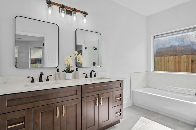 bathroom featuring independent shower and bath, vanity, and tile patterned floors