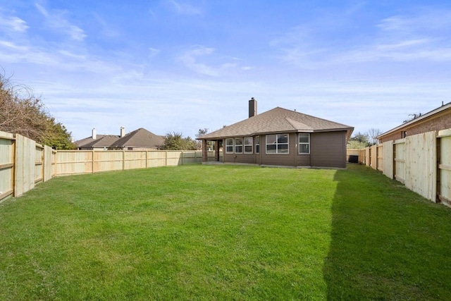 rear view of property featuring a lawn