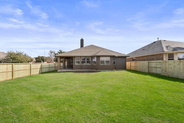 rear view of property featuring a patio and a lawn