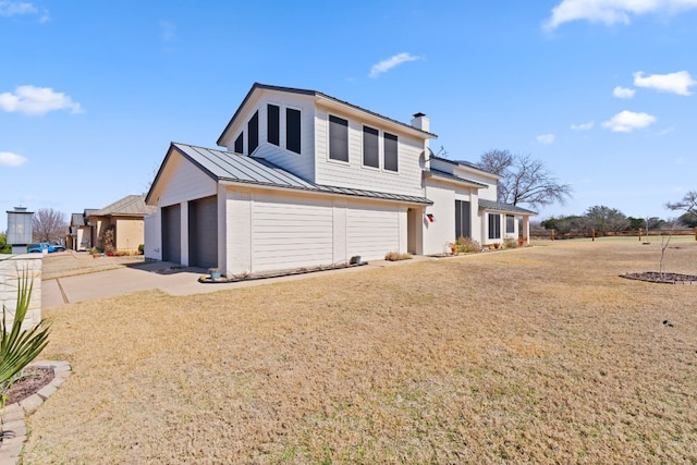 view of property with a garage and a front lawn