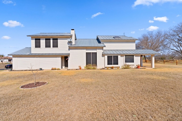 1210 Sun Ray, Horseshoe Bay, TX 78657 - rear view of house with a standing seam roof, a metal roof, a yard, and a chimney