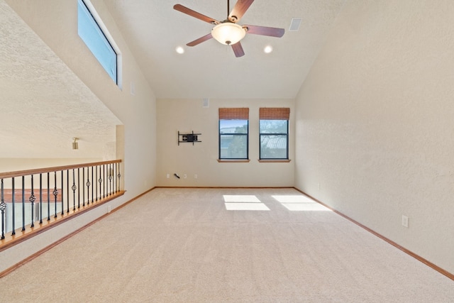 spare room featuring high vaulted ceiling, light carpet, a textured ceiling, and ceiling fan