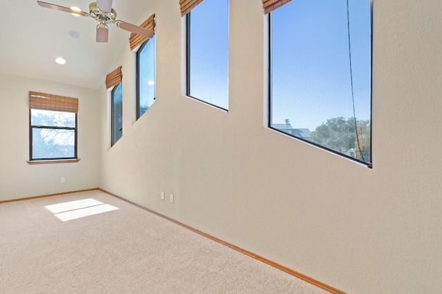 carpeted empty room featuring ceiling fan