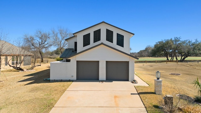 exterior space featuring a garage and a front lawn