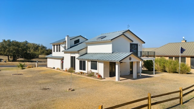 1210 Sun Ray, Horseshoe Bay, TX 78657 - modern farmhouse with a standing seam roof, a metal roof, and a balcony