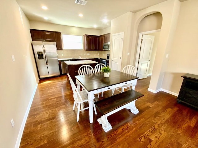 dining space with dark hardwood / wood-style floors