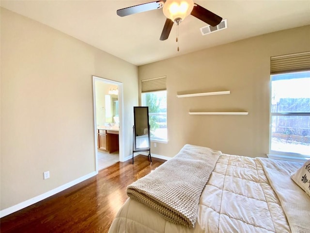 bedroom with ceiling fan, connected bathroom, and hardwood / wood-style floors