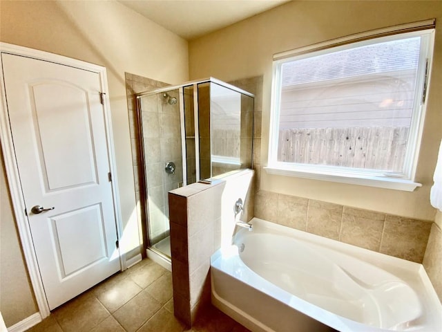 bathroom featuring tile patterned flooring and shower with separate bathtub