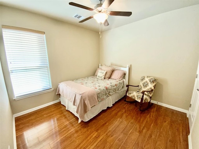 bedroom with hardwood / wood-style flooring and ceiling fan