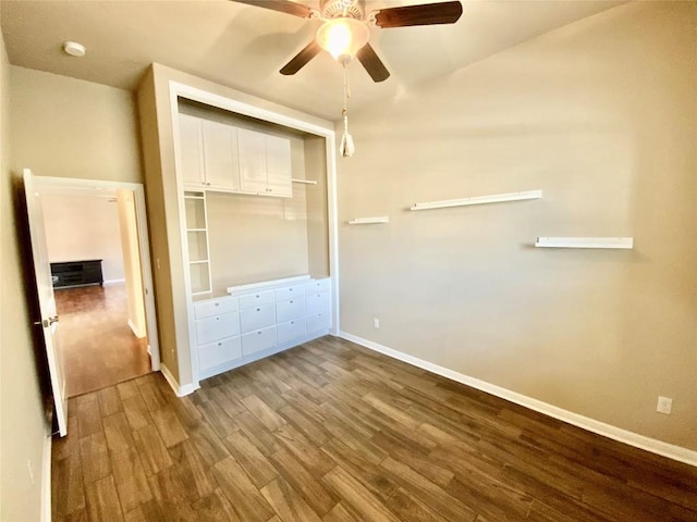 unfurnished bedroom with wood-type flooring, ceiling fan, and a closet