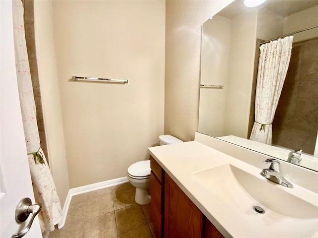 bathroom featuring tile patterned flooring, vanity, toilet, and walk in shower