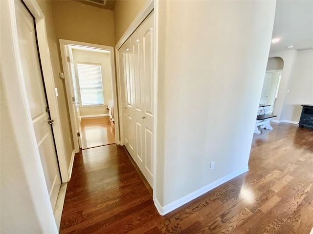 hallway with dark hardwood / wood-style floors