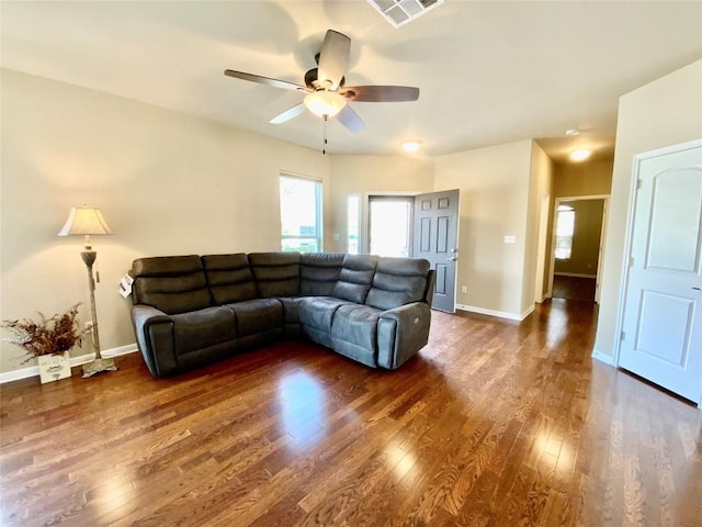 living room with ceiling fan and dark hardwood / wood-style flooring