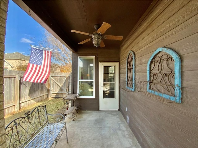 unfurnished sunroom with ceiling fan