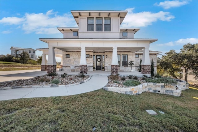 view of front of property with a front yard and covered porch