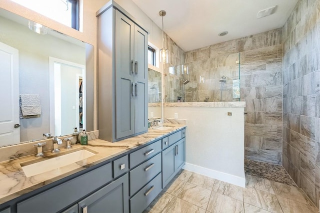 bathroom featuring vanity and tiled shower