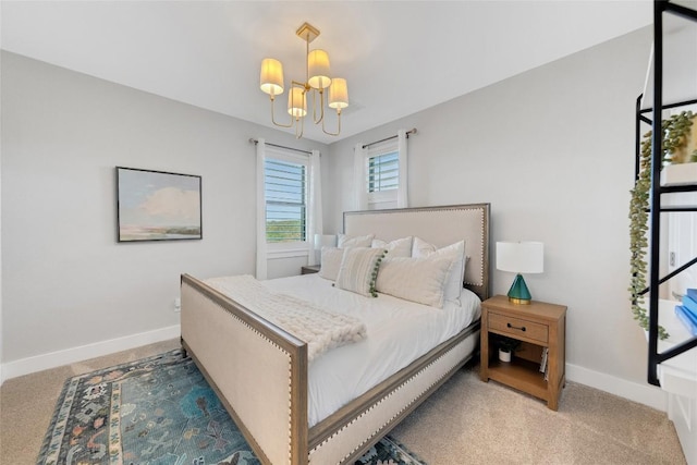 carpeted bedroom featuring a notable chandelier