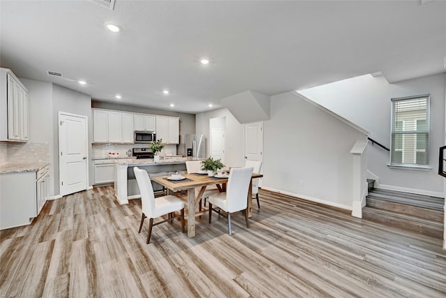 dining room with light wood-type flooring