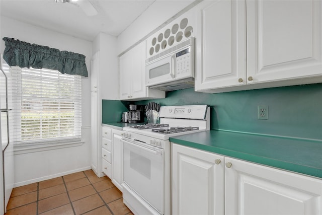 kitchen featuring white cabinetry, light tile patterned flooring, and white appliances