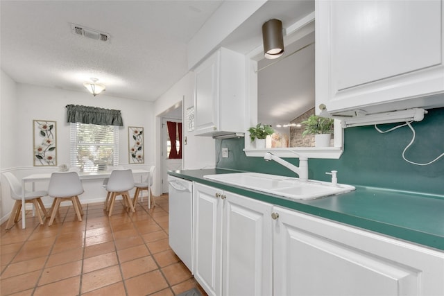 kitchen featuring white cabinetry, white dishwasher, sink, and a textured ceiling