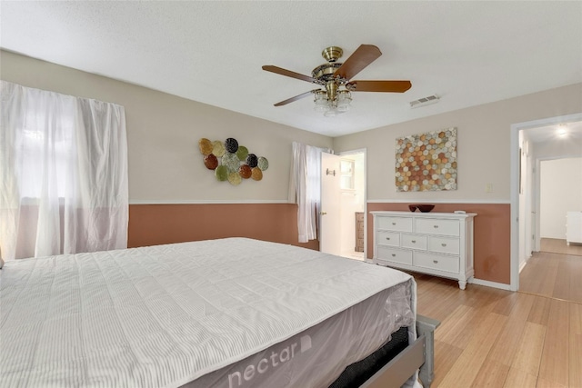 bedroom with ceiling fan and light hardwood / wood-style floors