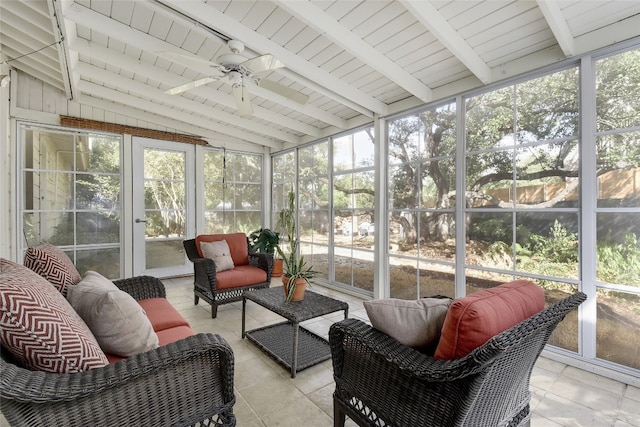 sunroom / solarium featuring ceiling fan, a wealth of natural light, and vaulted ceiling with beams