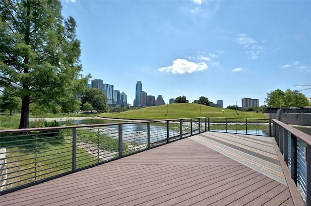 wooden terrace featuring a water view