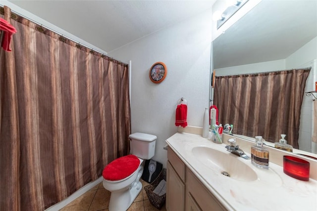 bathroom featuring tile patterned floors, toilet, and vanity