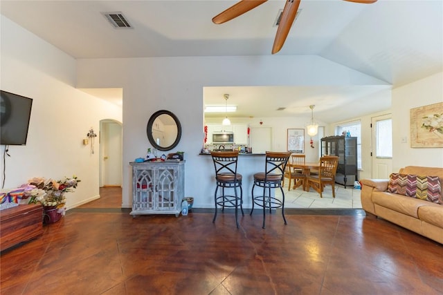 living room with vaulted ceiling and ceiling fan