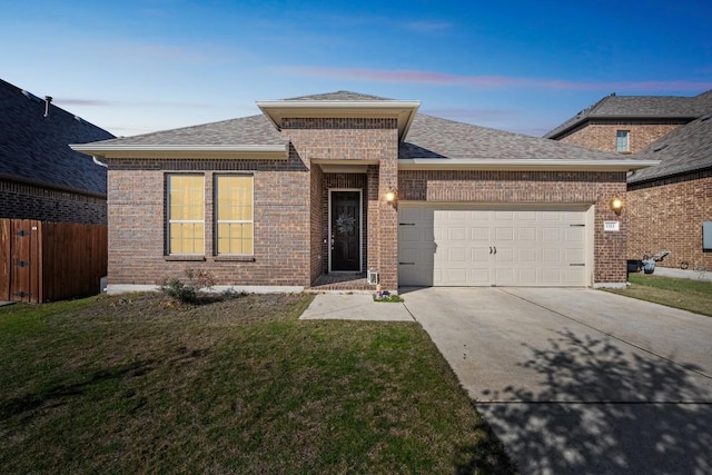 view of front of property featuring a garage and a yard