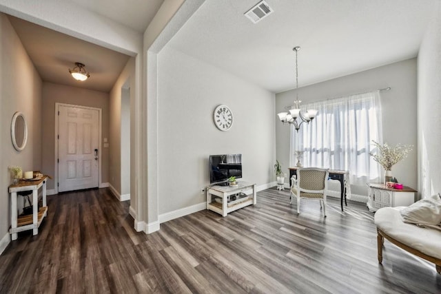 interior space with dark hardwood / wood-style floors and a notable chandelier