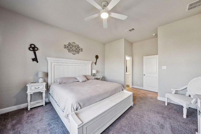 carpeted bedroom with ensuite bath and ceiling fan