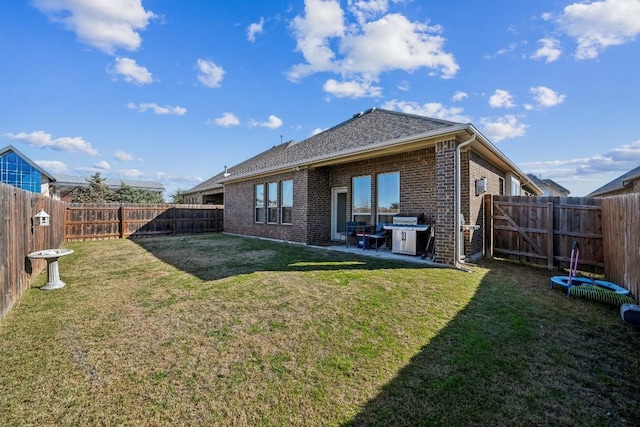 rear view of house with a patio and a lawn