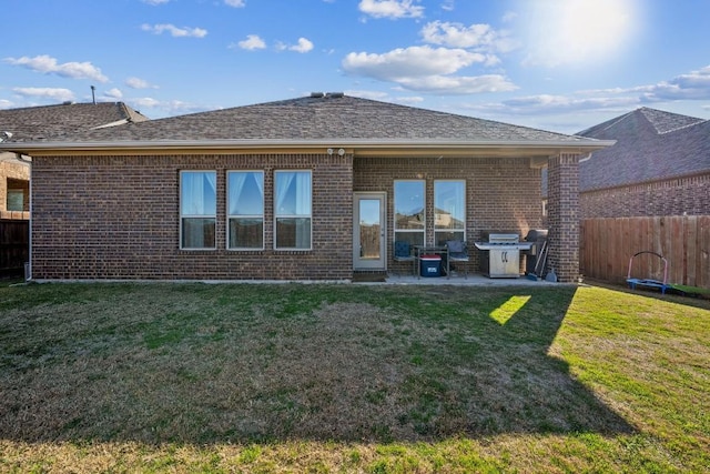 back of house featuring a yard and a patio area