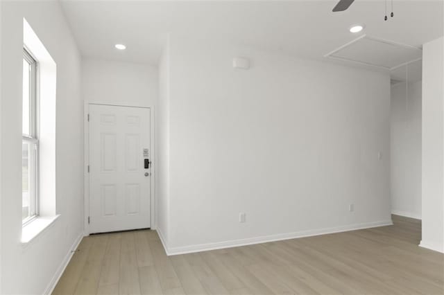 unfurnished room featuring baseboards, light wood finished floors, a ceiling fan, and recessed lighting